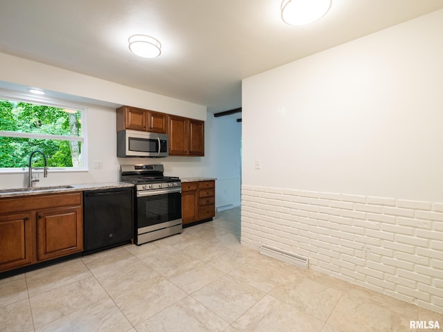743 W Wonderview Dr, Dunlap, IL 61525 - kitchen with appliances with stainless steel finishes, brown cabinets, light stone countertops, and light tile patterned flooring