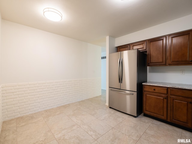 743 W Wonderview Dr, Dunlap, IL 61525 - kitchen with freestanding refrigerator and light tile patterned floors