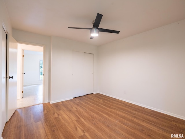 743 W Wonderview Dr, Dunlap, IL 61525 - unfurnished bedroom with light wood-type flooring, a closet, and a ceiling fan