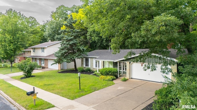 743 W Wonderview Dr, Dunlap, IL 61525 - view of front facade with concrete driveway, brick siding, an attached garage, a front yard, and roof with shingles