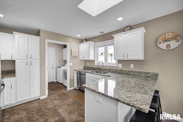 1619 Holland Ct, Chillicothe, IL 61523 - kitchen featuring dishwasher, a peninsula, white cabinetry, a kitchen breakfast bar, and light stone counters