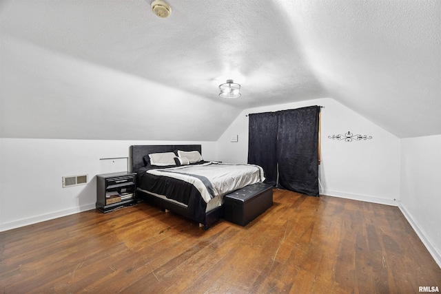 1900 S Airport Rd, Peoria, IL 61607 - bedroom featuring hardwood / wood-style flooring, a textured ceiling, and vaulted ceiling