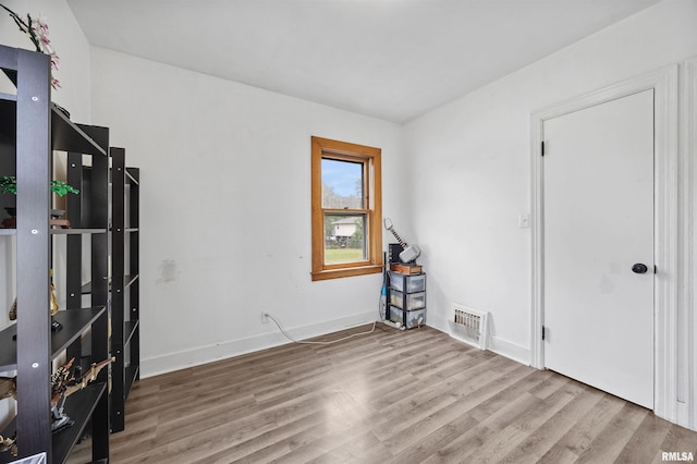 1900 S Airport Rd, Peoria, IL 61607 - spare room featuring wood finished floors and baseboards