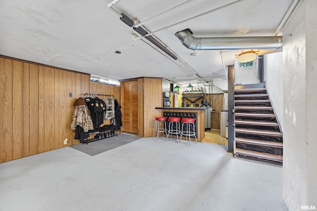 1900 S Airport Rd, Peoria, IL 61607 - finished below grade area with a bar, stairway, and wooden walls