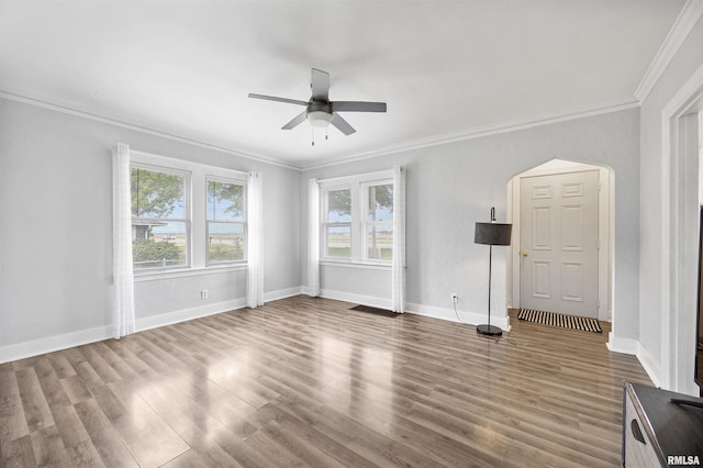 1900 S Airport Rd, Peoria, IL 61607 - unfurnished living room featuring crown molding, wood finished floors, ceiling fan, and arched walkways