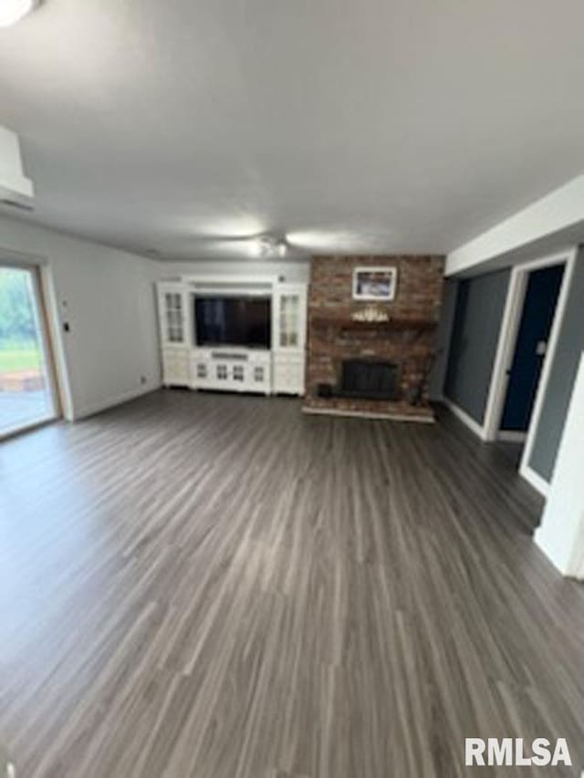 8109 N Blackbridge Rd, Edwards, IL 61528 - unfurnished living room featuring a fireplace and wood finished floors