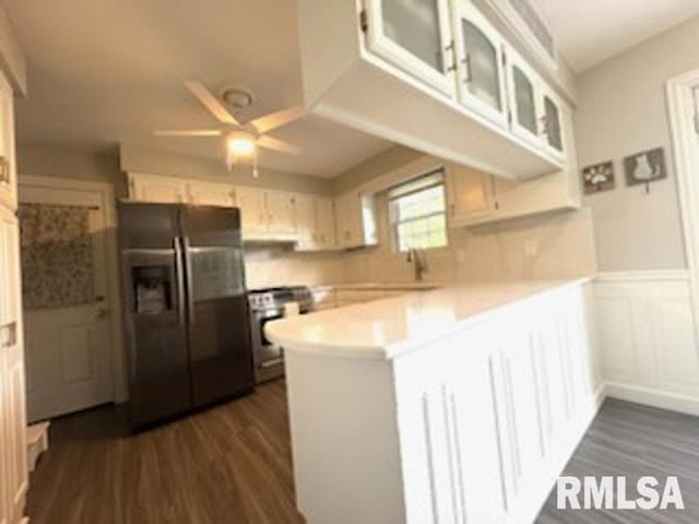 8109 N Blackbridge Rd, Edwards, IL 61528 - kitchen with appliances with stainless steel finishes, a peninsula, dark wood-style floors, ceiling fan, and light countertops