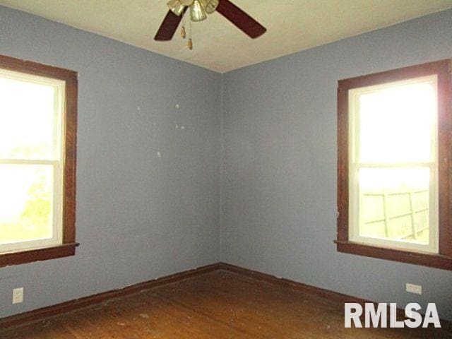 320 E Meadow Lawn St, Manito, IL 61546 - spare room featuring healthy amount of natural light, wood finished floors, and ceiling fan