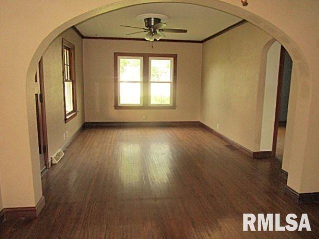 320 E Meadow Lawn St, Manito, IL 61546 - spare room featuring a ceiling fan, wood finished floors, crown molding, and arched walkways