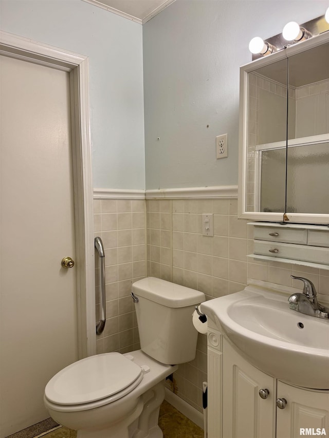 3813 W Brighton Ave, Peoria, IL 61615 - bathroom featuring tile walls, vanity, and a wainscoted wall