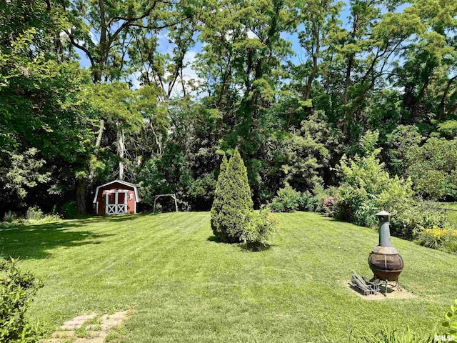 3813 W Brighton Ave, Peoria, IL 61615 - view of grassy yard with a fire pit and a shed