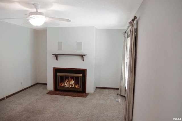 1003 Tonti Rd, Toulon, IL 61483 - unfurnished living room with carpet flooring, ceiling fan, and a fireplace with flush hearth