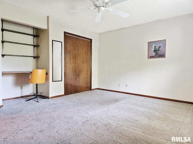 1003 Tonti Rd, Toulon, IL 61483 - unfurnished bedroom featuring carpet, a closet, a ceiling fan, and a textured ceiling