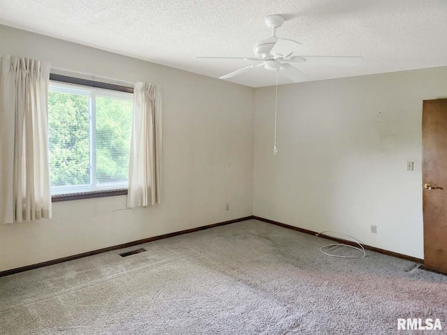 1003 Tonti Rd, Toulon, IL 61483 - spare room featuring carpet flooring, ceiling fan, and a textured ceiling