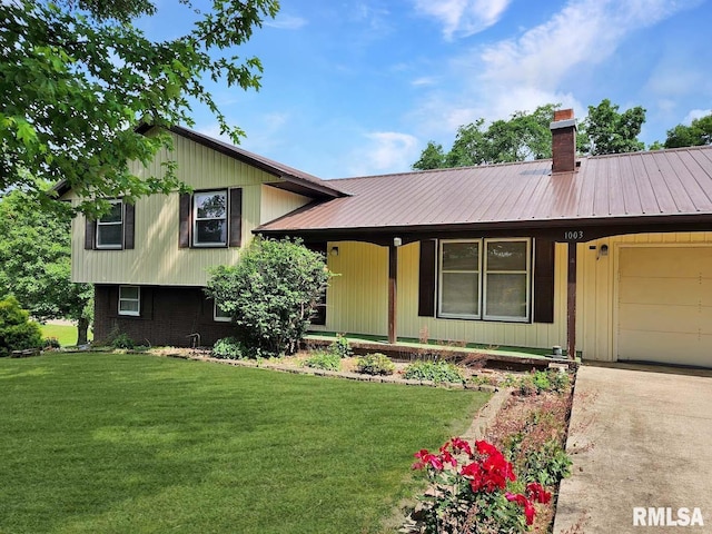 1003 Tonti Rd, Toulon, IL 61483 - split level home with a front lawn, a garage, a chimney, and a metal roof