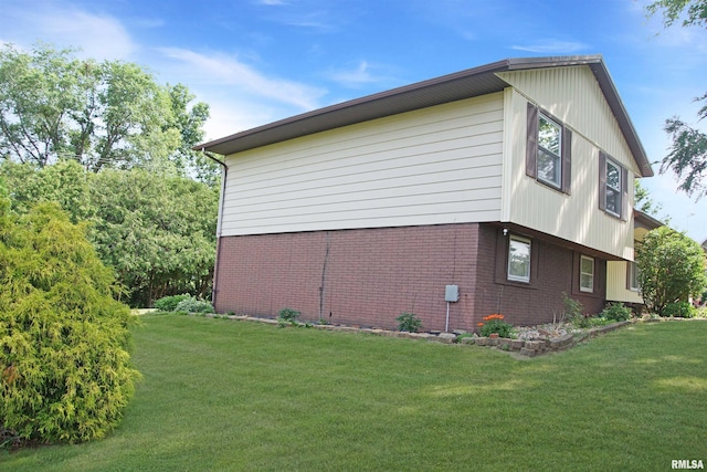 1003 Tonti Rd, Toulon, IL 61483 - view of property exterior featuring brick siding and a lawn