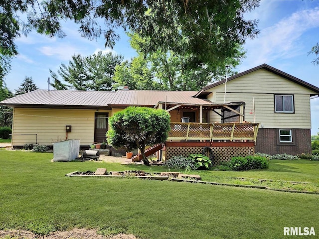 1003 Tonti Rd, Toulon, IL 61483 - rear view of house featuring a yard, a deck, and a metal roof