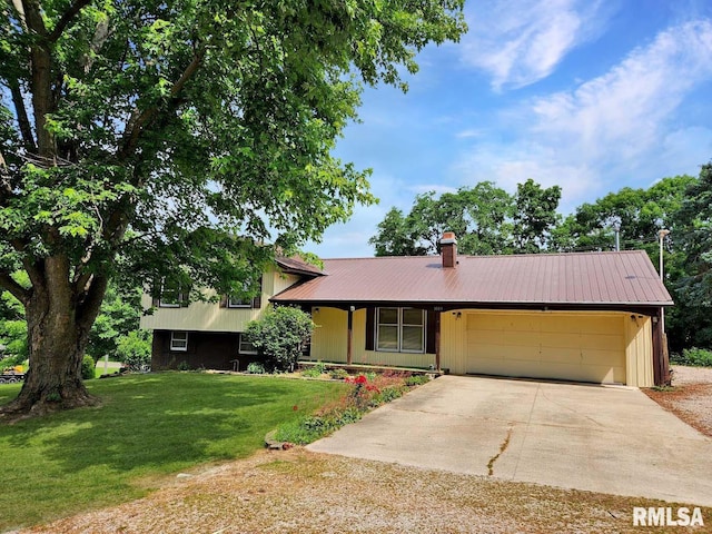 1003 Tonti Rd, Toulon, IL 61483 - split level home with driveway, a garage, a front lawn, a metal roof, and a chimney
