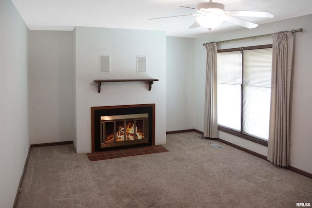 1003 Tonti Rd, Toulon, IL 61483 - unfurnished living room featuring carpet flooring, a fireplace with flush hearth, and a ceiling fan