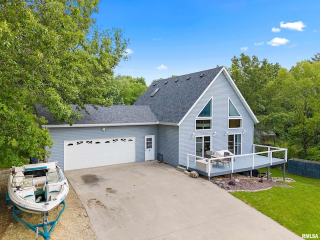 161 Lakecrest Pl, Dahinda, IL 61488 - back of property featuring a garage, concrete driveway, a wooden deck, a shingled roof, and a yard