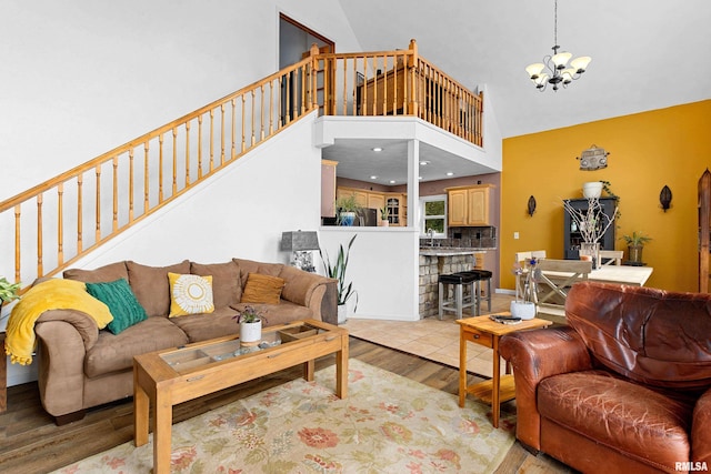 161 Lakecrest Pl, Dahinda, IL 61488 - living area with light wood-type flooring, stairs, a chandelier, and a towering ceiling