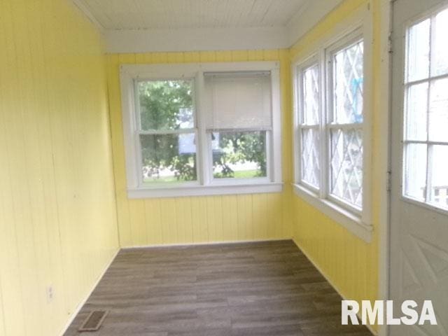 335 W Walnut St, Washburn, IL 61570 - unfurnished sunroom featuring wood finished floors and wooden walls