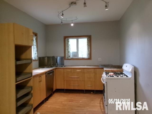 335 W Walnut St, Washburn, IL 61570 - kitchen featuring white range with gas stovetop, stainless steel dishwasher, light brown cabinets, light wood-style floors, and light countertops