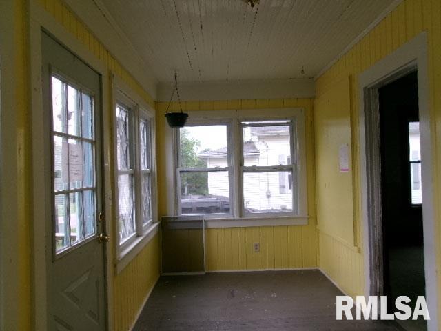 335 W Walnut St, Washburn, IL 61570 - unfurnished sunroom featuring healthy amount of natural light and wooden walls