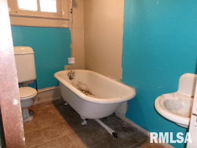 335 W Walnut St, Washburn, IL 61570 - bathroom featuring a freestanding tub and tile patterned floors