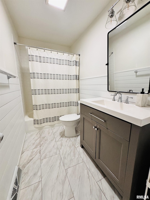 702 S Pearl St, Macomb, IL 61455 - bathroom featuring vanity, marble look tile flooring, wainscoting, and shower / bath combination with curtain
