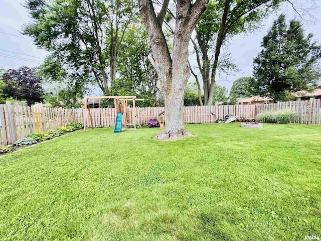 702 S Pearl St, Macomb, IL 61455 - fenced backyard featuring a playground