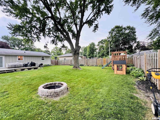 702 S Pearl St, Macomb, IL 61455 - fenced backyard with a playground and an outdoor fire pit