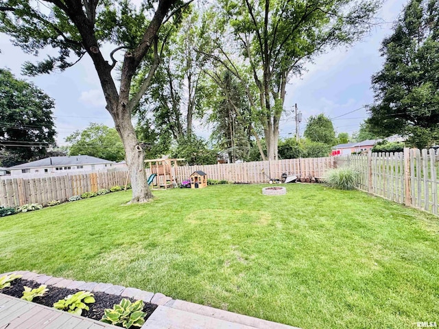 702 S Pearl St, Macomb, IL 61455 - fenced backyard with a playground