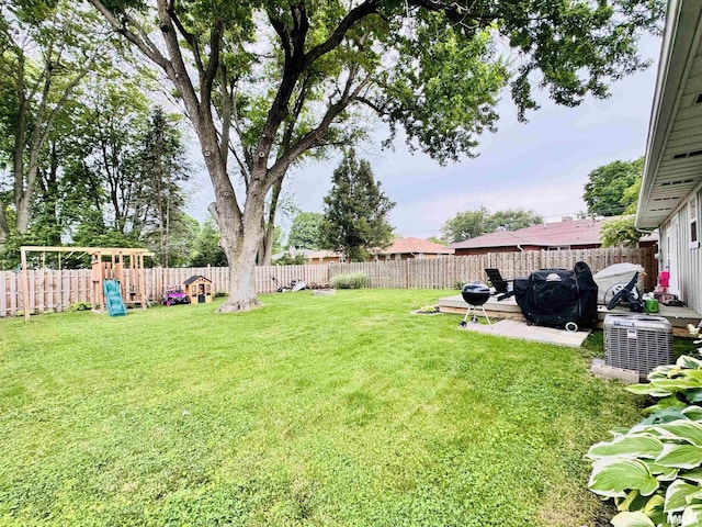 702 S Pearl St, Macomb, IL 61455 - fenced backyard featuring a playground