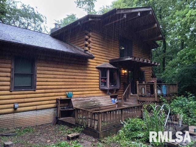 130 Zimmerman Rd, Spring Bay, IL 61611 - rear view of property featuring a deck, a shingled roof, a chimney, and log exterior