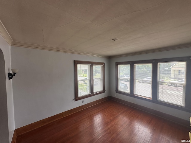 209 E Corrington Ave, Peoria, IL 61603 - unfurnished room with ornamental molding, dark wood-style flooring, and arched walkways