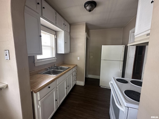 209 E Corrington Ave, Peoria, IL 61603 - kitchen with white appliances, dark wood-type flooring, white cabinets, light countertops, and arched walkways