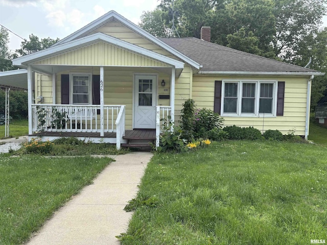 626 N Main St, Lewistown, IL 61542 - bungalow-style home featuring a chimney, a front lawn, a porch, and roof with shingles
