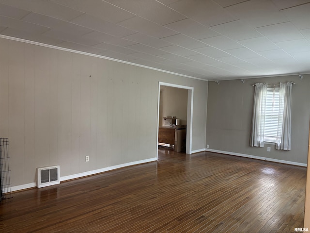 626 N Main St, Lewistown, IL 61542 - unfurnished room with dark wood-style flooring, crown molding, and wooden walls