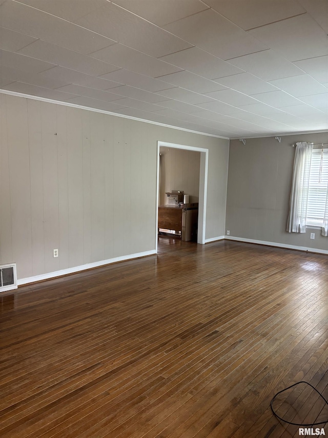 626 N Main St, Lewistown, IL 61542 - spare room with dark wood finished floors and wooden walls