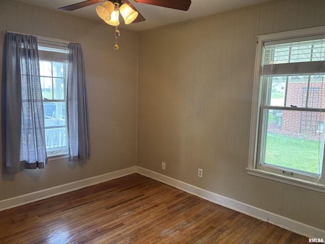 626 N Main St, Lewistown, IL 61542 - empty room with wood-type flooring, a ceiling fan, and ornamental molding