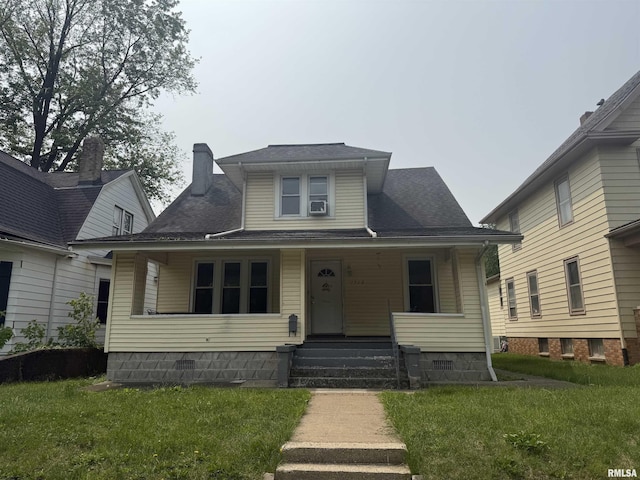 1712 W Bradley Ave, Peoria, IL 61606 - bungalow-style house featuring a front lawn and covered porch