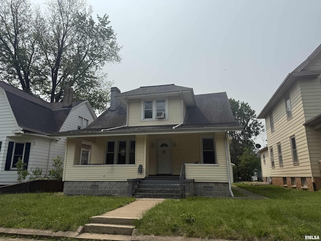 1712 W Bradley Ave, Peoria, IL 61606 - view of front facade featuring a front lawn, covered porch, a chimney, and a shingled roof
