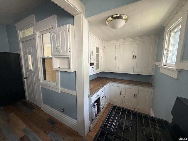 1712 W Bradley Ave, Peoria, IL 61606 - kitchen with wood finished floors and white cabinetry