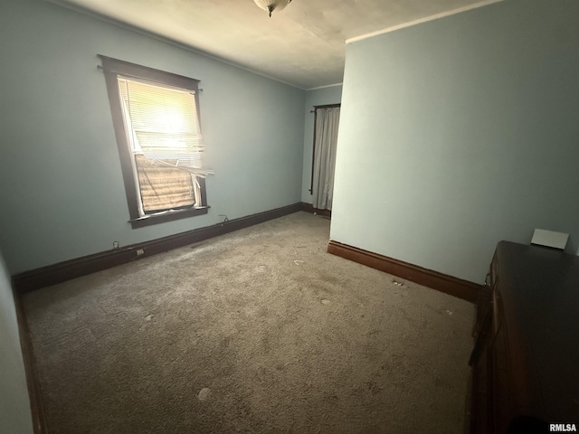 1712 W Bradley Ave, Peoria, IL 61606 - carpeted empty room with baseboards and crown molding