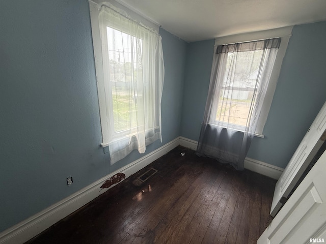 1712 W Bradley Ave, Peoria, IL 61606 - empty room featuring dark wood-style flooring and baseboards