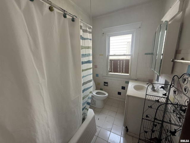 1712 W Bradley Ave, Peoria, IL 61606 - bathroom with tile patterned floors, tile walls, vanity, shower / bath combo, and wainscoting