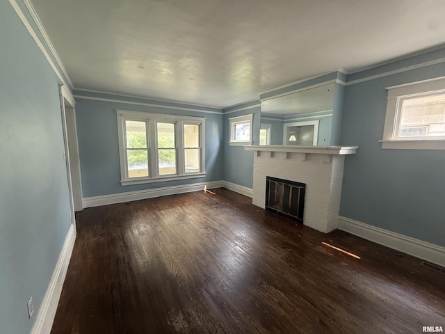 1712 W Bradley Ave, Peoria, IL 61606 - unfurnished living room featuring wood finished floors, a brick fireplace, and crown molding
