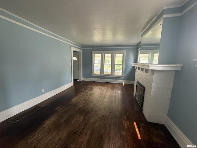 1712 W Bradley Ave, Peoria, IL 61606 - unfurnished living room featuring dark wood finished floors, ornamental molding, and a fireplace