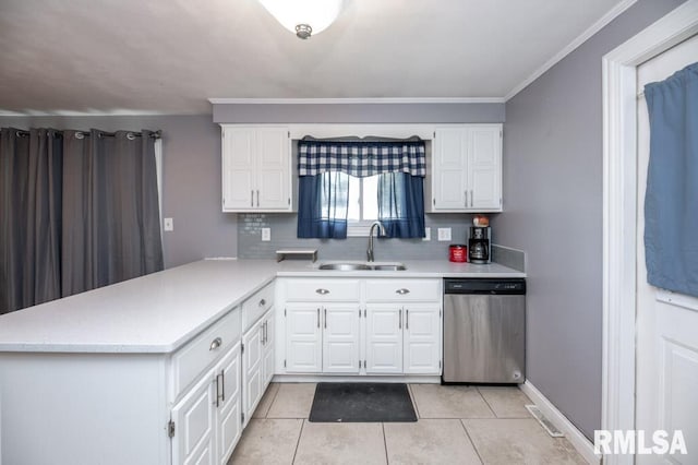 1200 Highview Rd, East Peoria, IL 61611 - kitchen with stainless steel dishwasher, light countertops, decorative backsplash, a peninsula, and white cabinetry